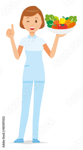 A female nurse wearing a white uniform has vegetables