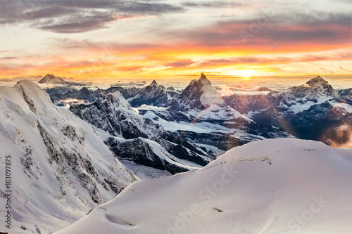 Sunset with mountains covered in snow photo