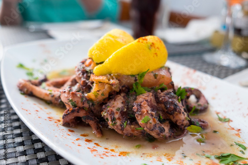 Freshly caught octopus grilled with garlic and olive oil and served with wine sauce at the traditional fishing village Marsaxlokk, Malta