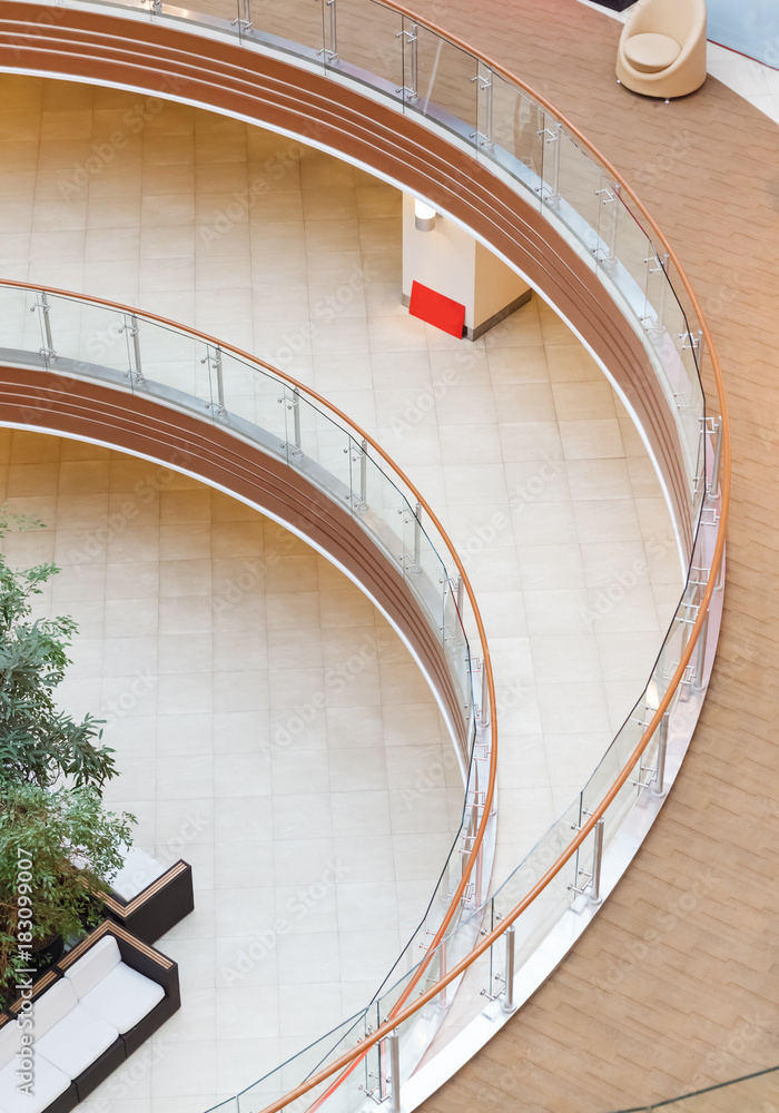 Fototapeta premium geometric patterns from multi-level balconies in the architecture of an empty shopping center building