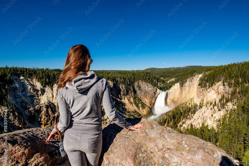 Tourist overlooking waterfall in Yellowstone