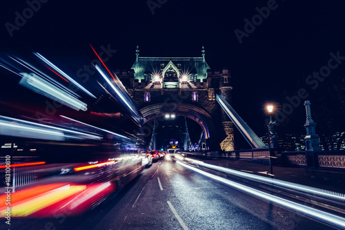 City light trails of London bus traffic on Tower Bridge in London at night