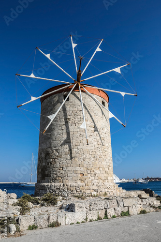 Mandhraki Harbor, the yacht and ferry harbour with windmills in the city of Rhodes in Greece