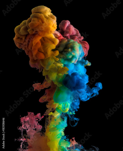 Rainbow acrylic color splash on black background