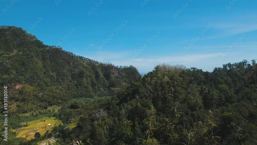 Mountains with rice terrace, farmlands, village, fields with crops, agricultural land of farmers. Aerial view mountains are covered with forest. Bali, Indonesia. 4K video. Aerial footage. Mountains with rice terrace, farmlands, village, fields with crops, agricultural land of farmers. Aerial view mountains are covered with forest. Bali, Indonesia. 4K video. Aerial footage.