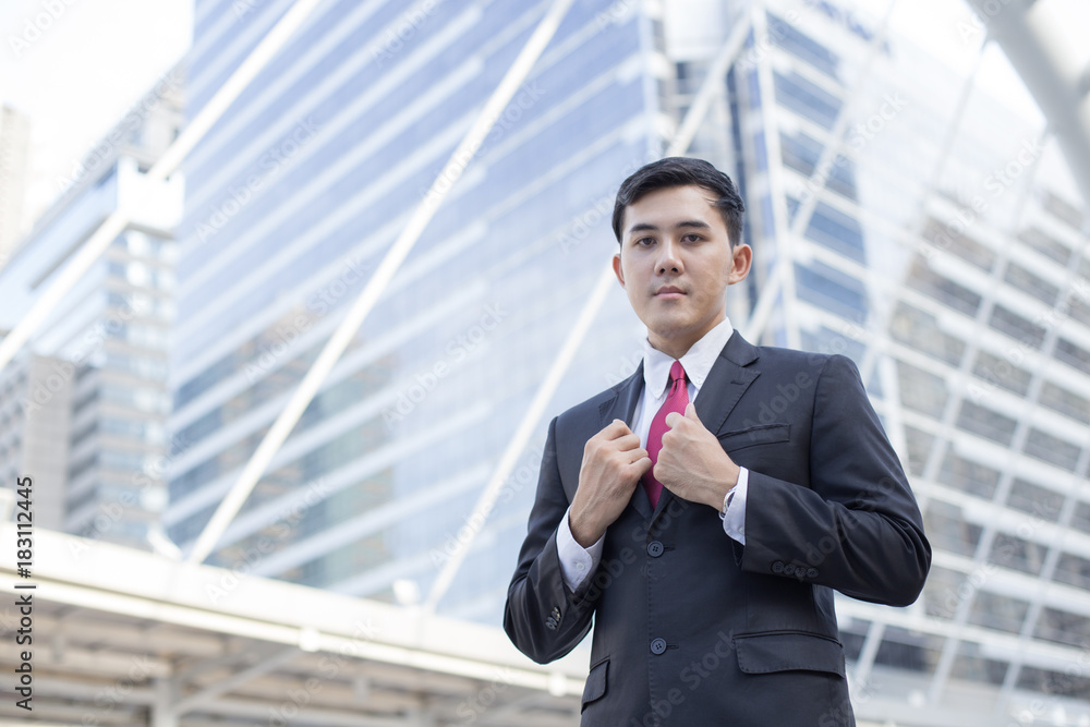 Young Hnadsome Businessman standing in City looking and ready for Work. Young Businessman have Confident for Work with Leader concept. Asian Businessman Thinking for Work in City. Young Hnadsome Businessman standing in City looking and ready for Work. Young Businessman have Confident for Work with Leader concept. Asian Businessman Thinking for Work in City.