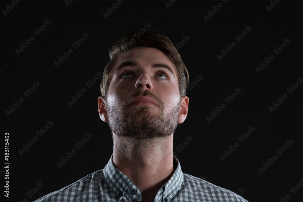 Obraz premium Man standing against black background