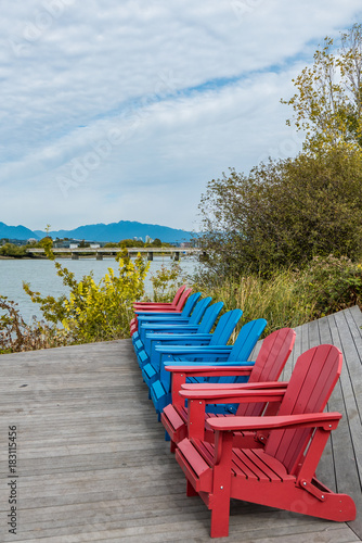red and blue chairs near the rive side