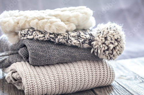 Fototapeta Naklejka Na Ścianę i Meble -  beautiful knitted clothes, neatly folded, close-up, handmade sweaters.