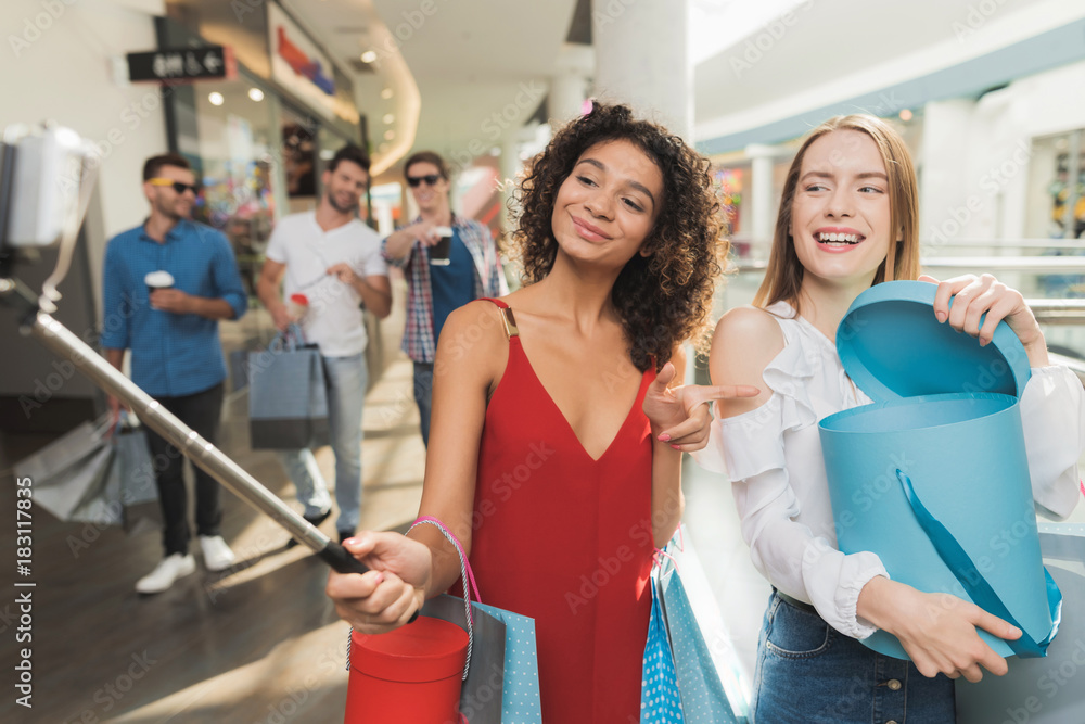 Girls are shopping at the mall. Sale in black Friday. Girls are shopping on a black Friday. Girls are shopping at the mall. Sale in black Friday. Girls are shopping on a black Friday.