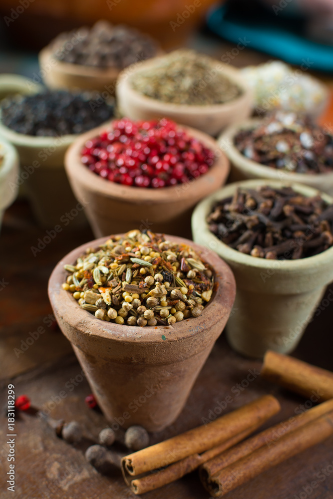 Variety of different asian and middle east spices, colorful assortment, on old wooden table Variety of different asian and middle east spices, colorful assortment, on old wooden table