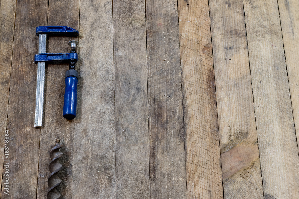 Tools on a wooden table in an old workshop. Arranged on the edge of the table. wooden table. Tools on a wooden table in an old workshop. Arranged on the edge of the table. wooden table.