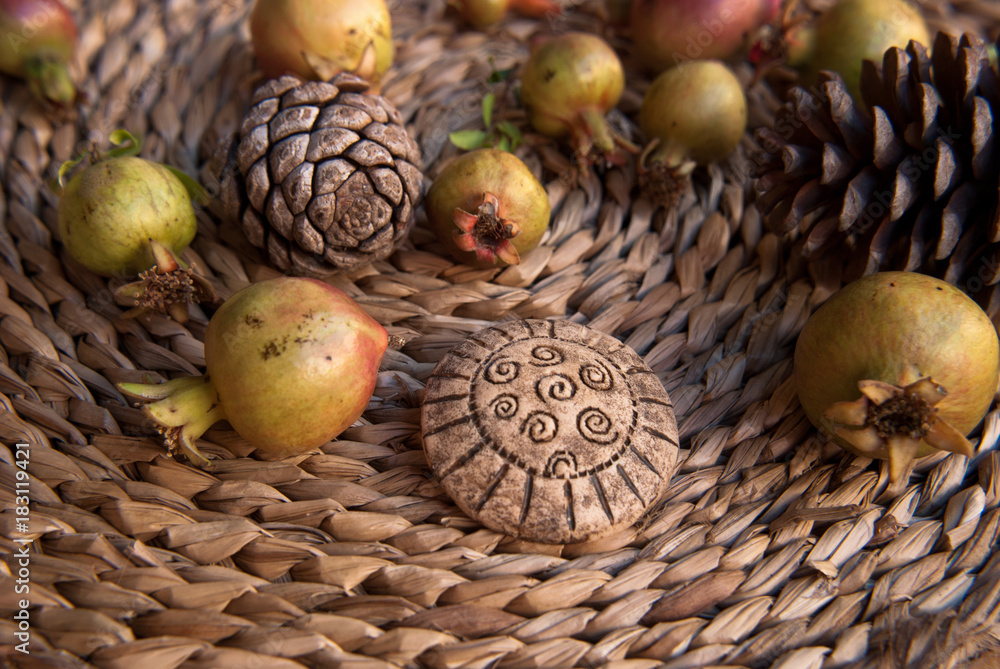 Tribal african brooch with small grenades in pastel tone. Handmade jewelry of polymer clay. Background with jewelry. Artwork still life. Tribal african brooch with small grenades in pastel tone. Handmade jewelry of polymer clay. Background with jewelry. Artwork still life.