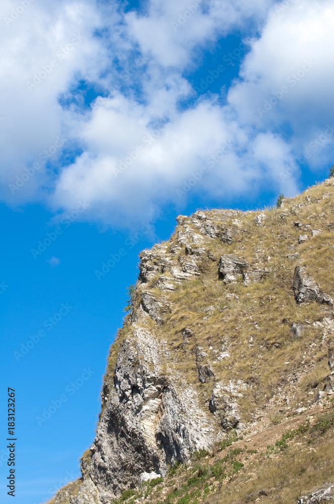 photograph of a mountain landscape on the blue sky background
