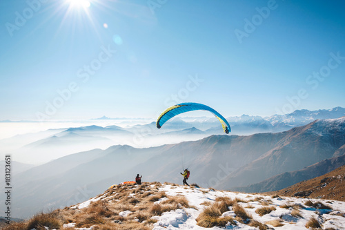 taking picture to a paraglider takeoff on the mountain. Italian Alps