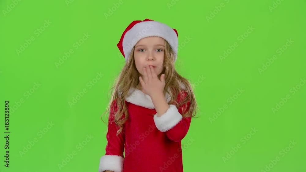Baby girl in red Christmas caps send air kisses. Green screen Baby girl in red Christmas caps send air kisses. Green screen