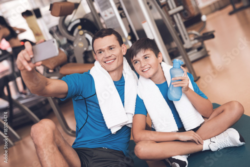 Dad and son in the same clothes in gym. Father and son lead a healthy lifestyle.