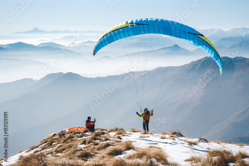 taking picture to a paraglider takeoff on the mountain. Italian Alps