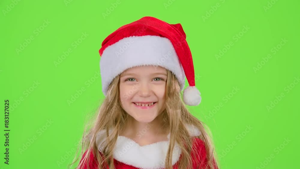 Baby in a beautiful suit and a red New Year's cap smiles. Green screen Baby in a beautiful suit and a red New Year's cap smiles. Green screen