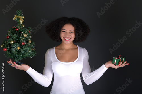 afro american woman with christmas tree photo