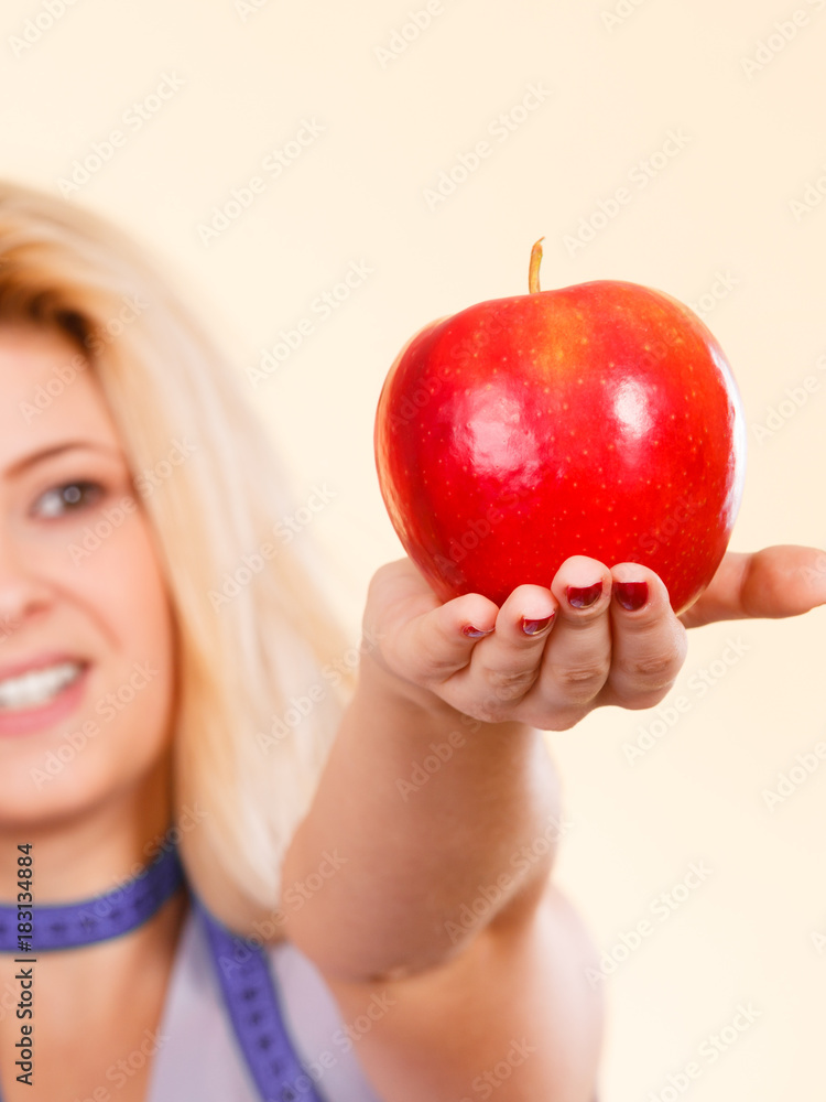 Happy woman holding delicious red apple Happy woman holding delicious red apple