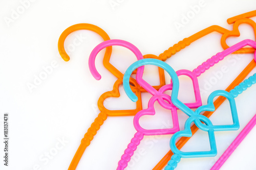 Top view of colorful clothes hangers isolated on white background. (Selective focus)