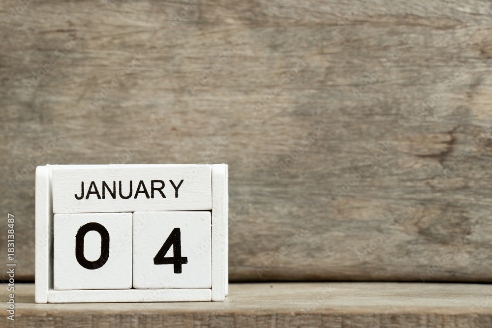 White block calendar present date 4 and month january on wood background White block calendar present date 4 and month january on wood background