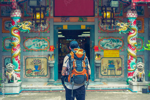 Backpacker man in chinese temple in the street of Asia. Bangkok, Thailand.