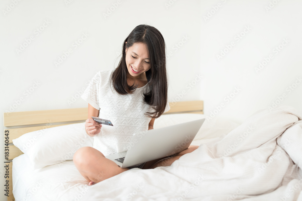 Excited woman using notebook computer for online shopping at home Excited woman using notebook computer for online shopping at home