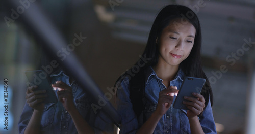 Photography Woman looking at cellphone in city