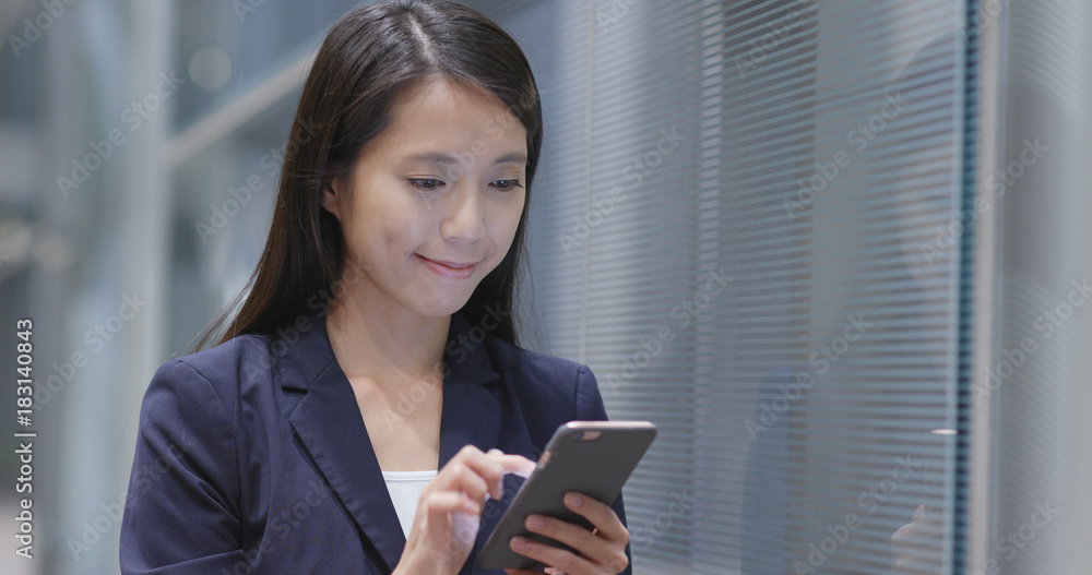 Businesswoman use of mobile phone out of office Businesswoman use of mobile phone out of office