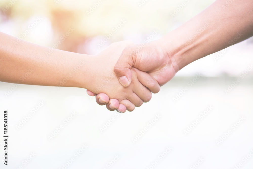 Closeup of a business hand shake between two colleagues Closeup of a business hand shake between two colleagues