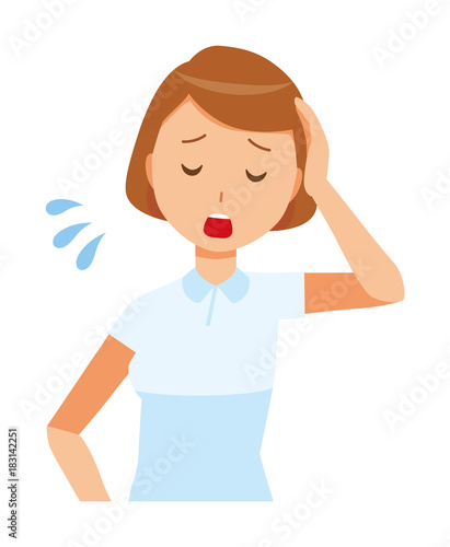 A woman nurse wearing a white uniform is tired