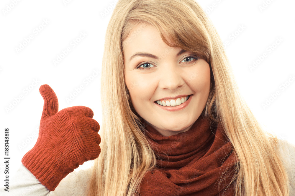 Happy smiling woman in woolen gloves showing thumbs up, positive human emotion concept Happy smiling woman in woolen gloves showing thumbs up, positive human emotion concept