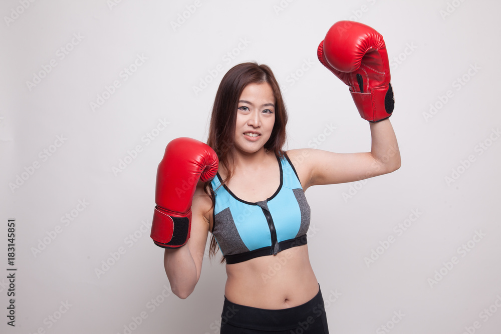 Beautiful healthy Asian girl with red boxing glove.