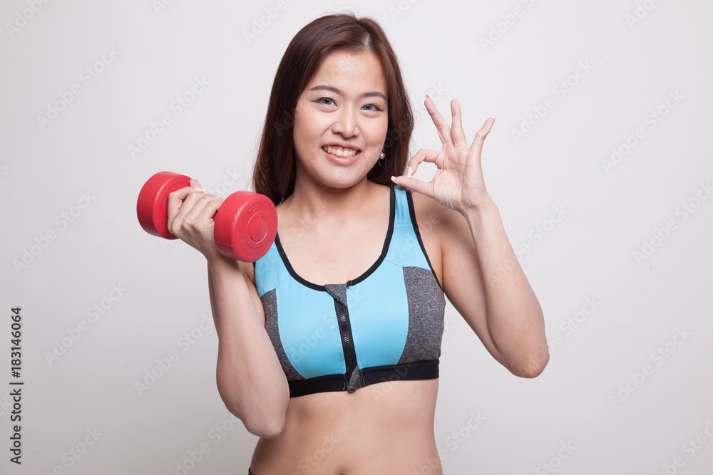 Beautiful Asian healthy girl show OK with dumbbell. Beautiful Asian healthy girl show OK with dumbbell.