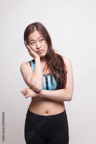 Beautiful young Asian woman in sport dress get bored. © halfbottle