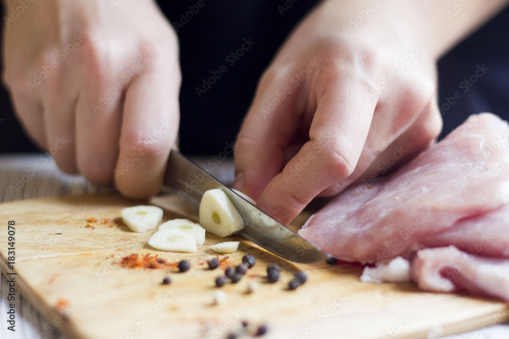 hands of chef cutting garlic on Board for seasoning meat hands of chef cutting garlic on Board for seasoning meat