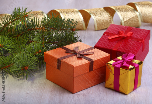 Christmas decoration with gift boxes and christmas tree on a blurry, sparkling and fabulous background.