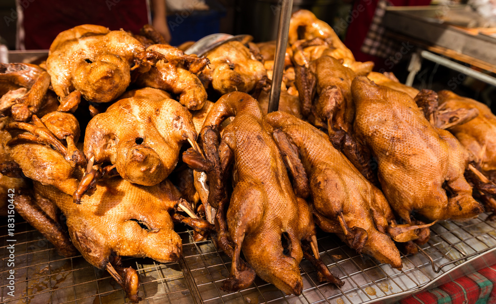 Naklejka premium Roasted duck in a showcase in front of store.