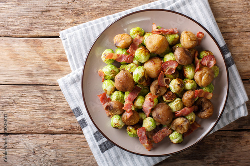 Fried chestnuts, brussels sprouts and bacon closeup. horizontal top view