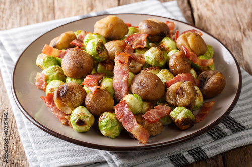 Delicious appetizer: roasted chestnuts, Brussels sprouts and bacon close-up. horizontal
