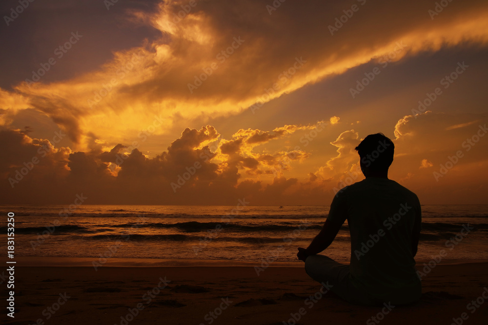 Yoga and meditation. Silhouette of Young man Yoga and meditation. Silhouette of Young man