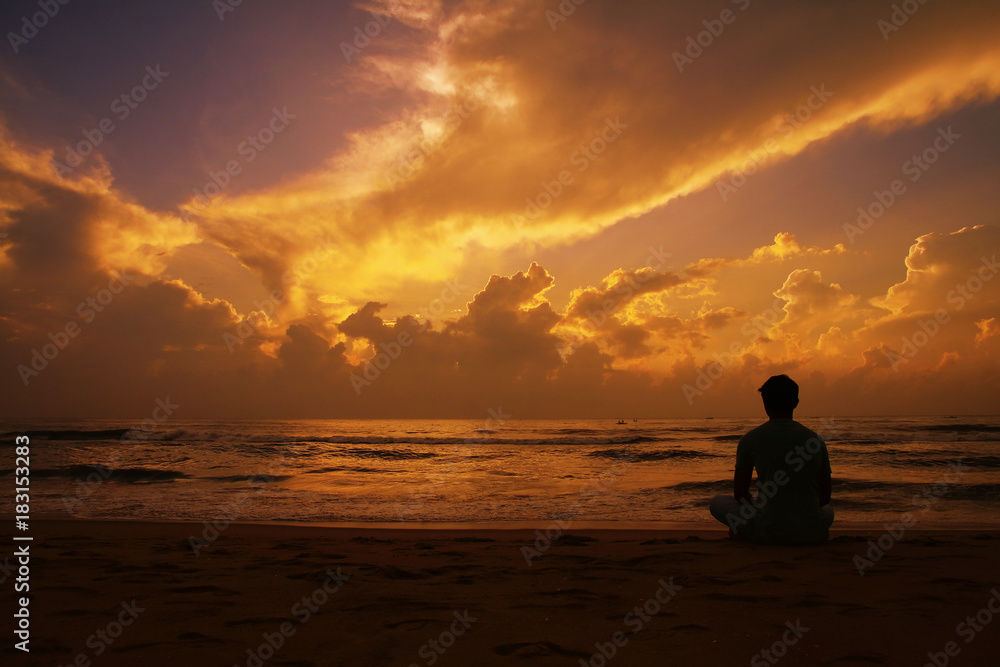  Yoga and meditation. Silhouette of Young man