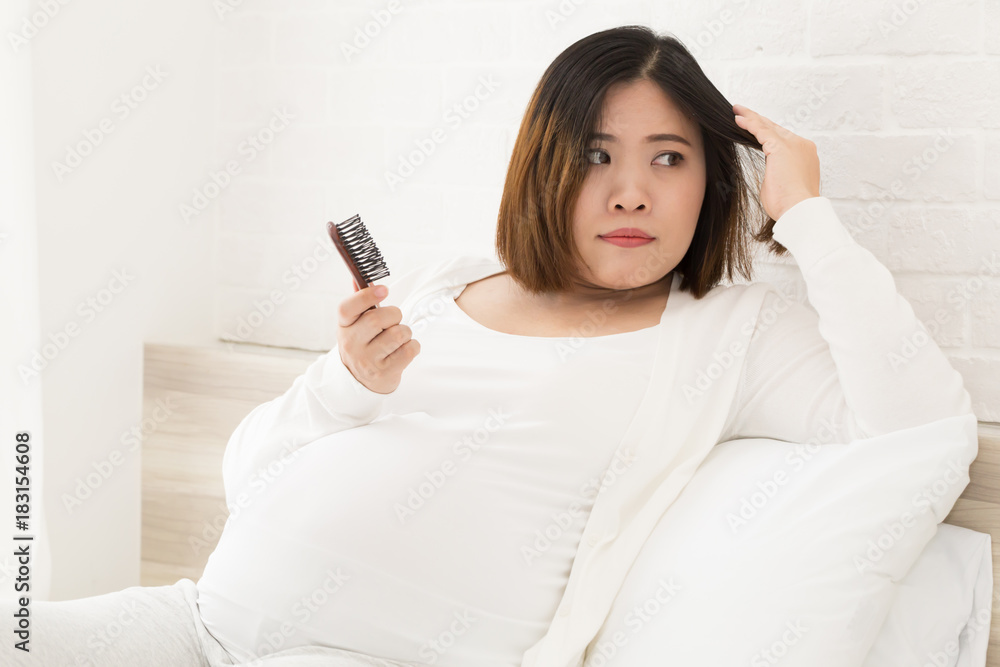 Asian pregnant woman can not making new hair color because it affects the  fetus Stock Photo | Adobe Stock