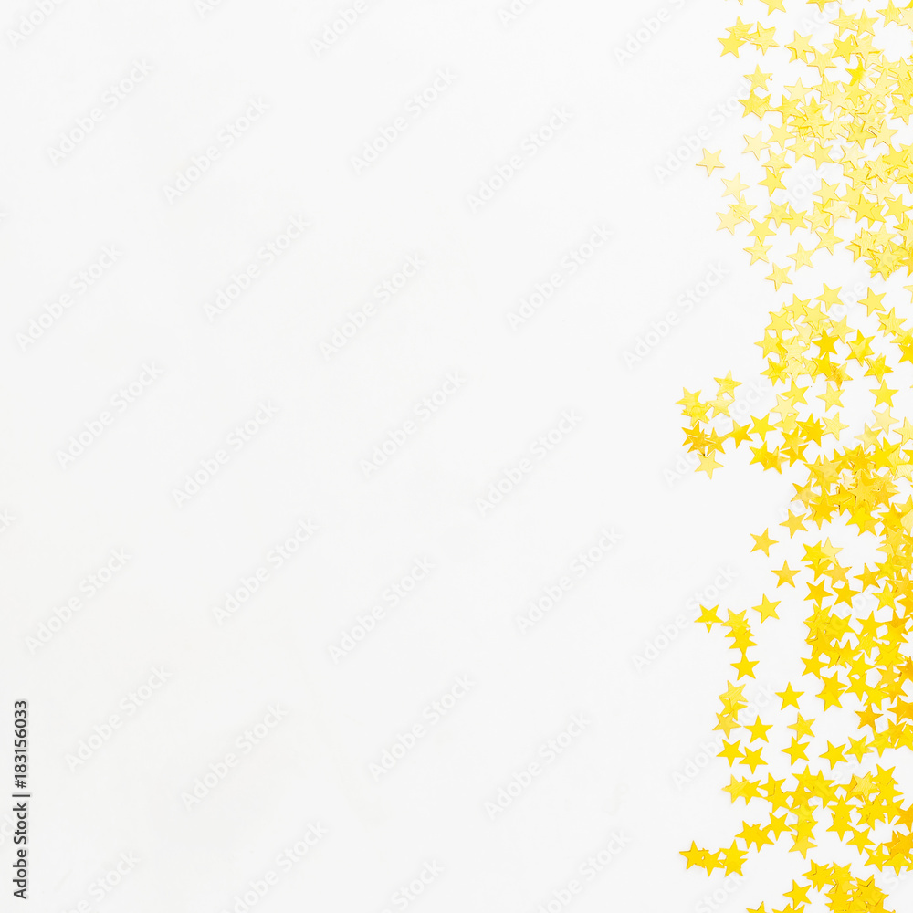 Golden confetti on white background. Flat lay, top view. Copy space Golden confetti on white background. Flat lay, top view. Copy space