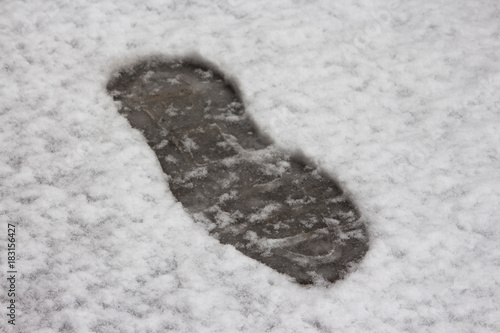 Human footprint in fresh, cold, wet and soft snow