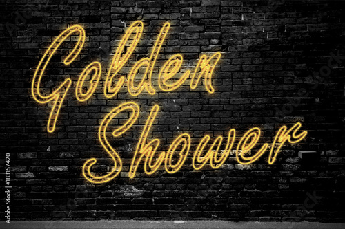 Leuchtreklame Golden Shower an Ziegelsteinmauer photo