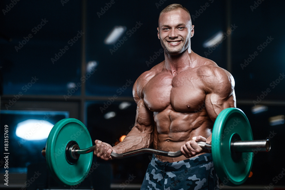 Brutal strong bodybuilder athletic men pumping up muscles with dumbbells. Brutal strong bodybuilder athletic men pumping up muscles with dumbbells.