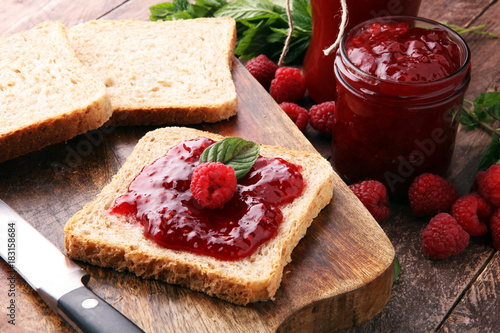 Fresh raspberry jam with toast or bread for breakfast. photo